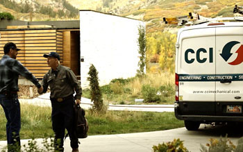CCI technician shaking a clients hand with a work vehicle in the background