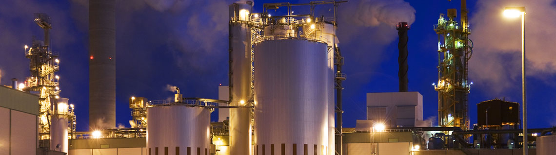 Industrial facility showcasing exterior buildings with smoke stacks 