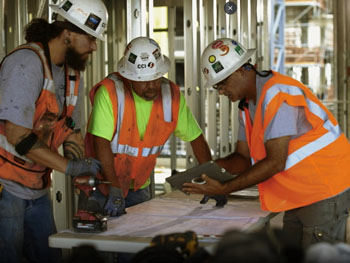 Construction workers at a job site wearing safety gear